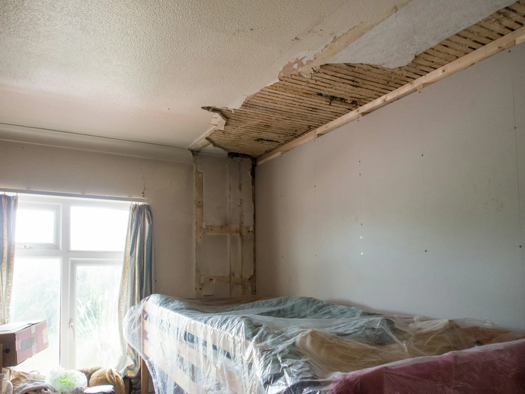 Older bedroom with a damaged ceiling